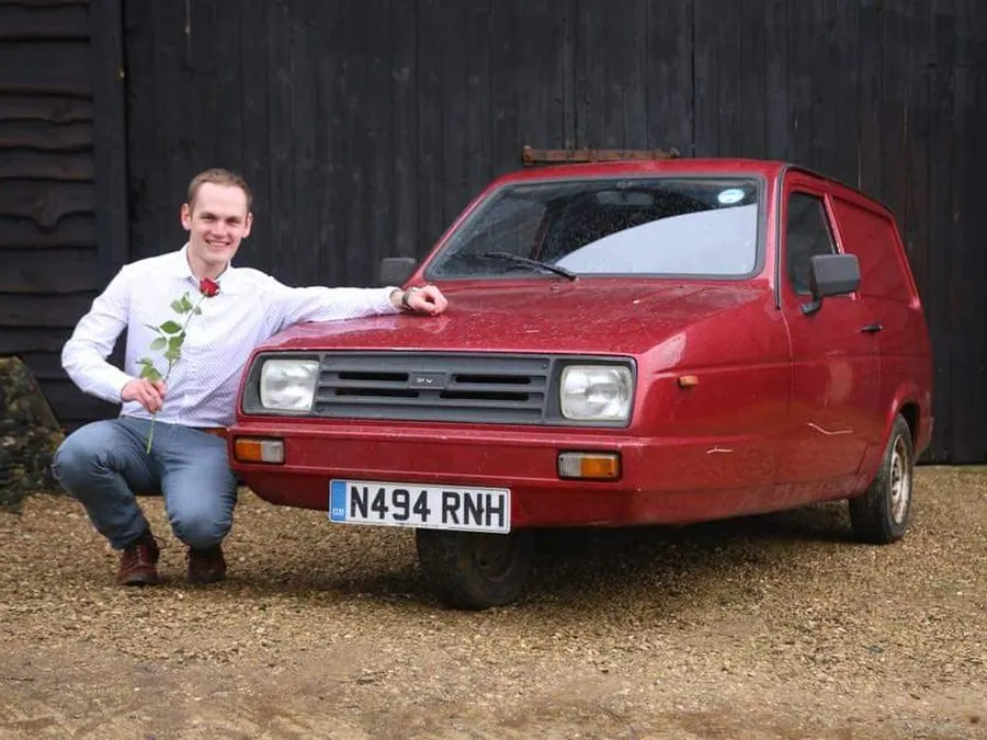 Kneeling next to a Reliant Robin with a rose, early Motoring Research days